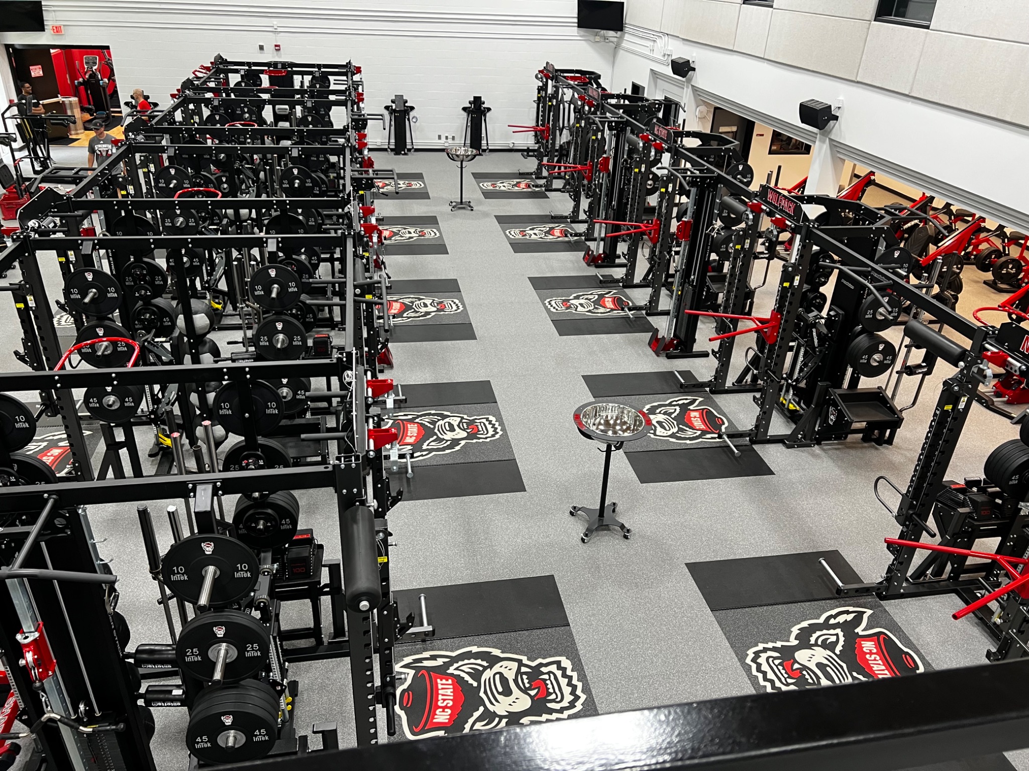 NC State Wolfpack weight room with rows of power racks